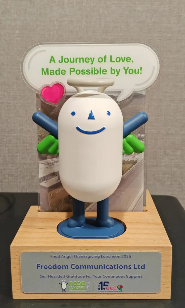 Food Angel mascot appreciation trophy presented to Freedom Communications